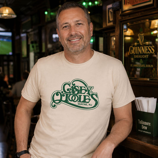 Man standing at a bar wearing Casey O'Tooles Wayne NJ retro t-shirt