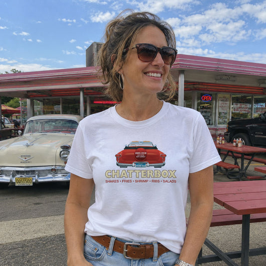 Woman standing at a classic car drive-in wearing The Chatterbox Drive-In Augusta NJ t-shirt
