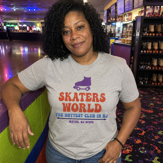 Woman smiling at a roller skating rink wearing Skaters World Wayne NJ retro t-shirt